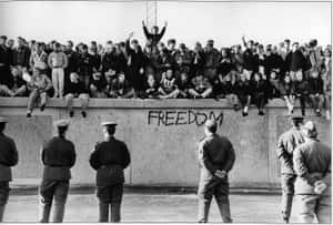 East German Students Celebrate Freedom Atop The Berlin Wall, 1989 Wallpaper