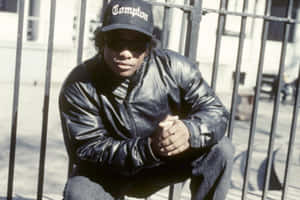 Eazy E Posing In Style Against A Graffiti Backdrop Wallpaper