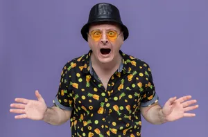 Eccentric Man Wearing A Fashionable, Bold, Printed Shirt Wallpaper