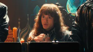 Eddie Munson In Stranger Things Sitting Down Wallpaper