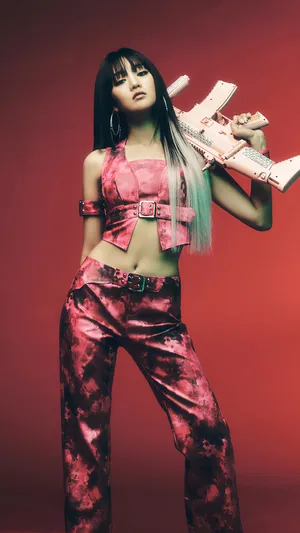 Edgy Fashion Posewith Guitar Gun Wallpaper