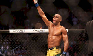 Edson Barboza Triumphantly Raising His Arm In The Ring Wallpaper