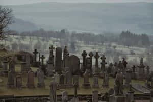 Eerie Gravestone In Foggy Cemetery Wallpaper