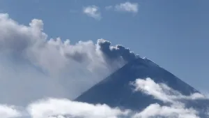 Effusive Smoke And Clouds Around A Volcano Wallpaper