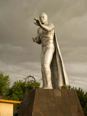 El Santo Statue Under Stormy Skies Wallpaper