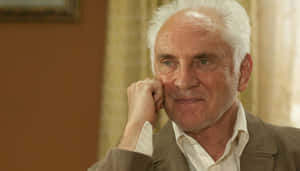 Elderly Man Contemplative Gaze Wallpaper