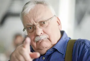 Elderly Man Gesturing With Hand Wallpaper