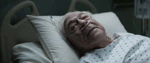 Elderly Man Hospital Bed Oxygen Therapy Wallpaper