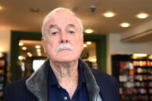 Elderly Man In Bookstore Wallpaper