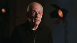 Elderly Man In Interview Setting Wallpaper