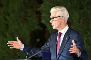 Elderly Man Speakingat Event Wallpaper