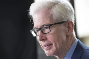 Elderly Manin Glassesand Suit Wallpaper