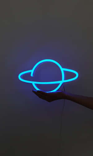 Electric Blue Neon Planet Floatingon Hand Wallpaper