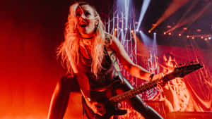 Electric Guitarist On Stage Performance Wallpaper