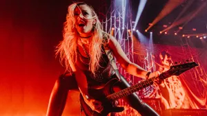 Electric Guitarist On Stage Performance Wallpaper