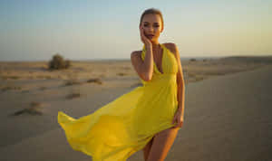 Elegance In Sunshine - Woman In A Vibrant Yellow Dress Wallpaper