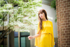 Elegance In Yellow - Woman Wearing A Beautiful Yellow Dress Wallpaper