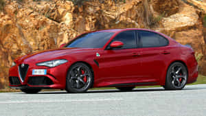 Elegant Alfa Romeo Giulia Cruising On The Road Wallpaper