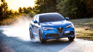 Elegant Alfa Romeo Stelvio On A Scenic Backdrop Wallpaper