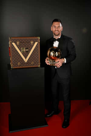 Elegant_ Athlete_ With_ Golden_ Ball_ Trophy Wallpaper