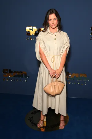 Elegant Beige Dress Event Wallpaper