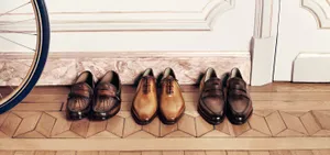 Elegant Berluti Men's Shoes On Display Wallpaper