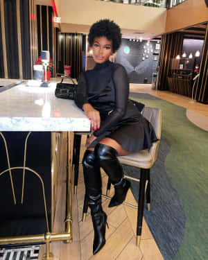 Elegant Black Dressand Boots Luxury Aesthetic Wallpaper