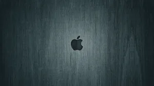 Elegant Black Macbook In A Minimalist Setting Wallpaper