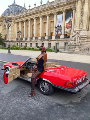 Elegant Black Woman Red Luxury Car Wallpaper