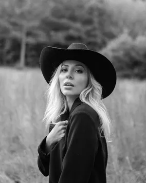 Elegant Blackand White Portraitof Womanin Hat Wallpaper