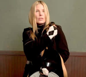 Elegant Blonde Womanin Black Coat Wallpaper