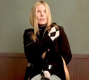 Elegant Blonde Womanin Black Coat Wallpaper