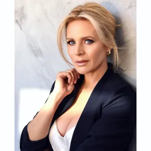 Elegant Blonde Womanin Blazer Wallpaper