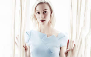 Elegant Blonde Womanin Blue Dress Wallpaper