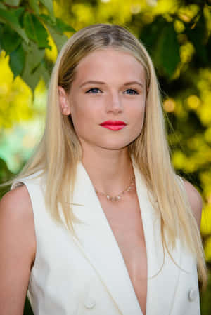 Elegant Blonde Womanin White Blazer Wallpaper