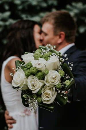 Elegant Bridal Bouquet In Bride's Hands Wallpaper