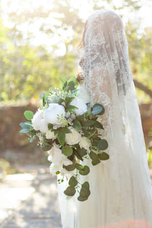 Elegant Bridal Bouquet With White Roses And Greenery Wallpaper