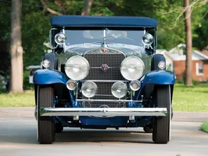Elegant Cadillac Fleetwood In A Stunning Backdrop Wallpaper