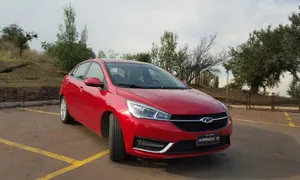 Elegant Chery Arrizo 5 In Vibrant City Lights Wallpaper