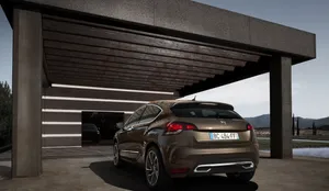 Elegant Citroën Ds4 In Night Cityscape Wallpaper