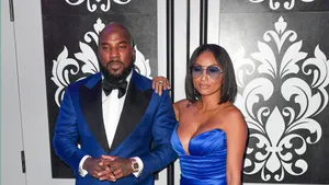 Elegant Couple Blue Black Event Attire Wallpaper