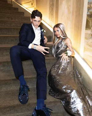 Elegant Couple Staircase Pose Wallpaper