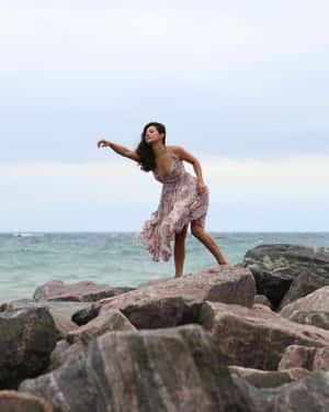 Elegant Dance Moveson Rocky Beach Wallpaper
