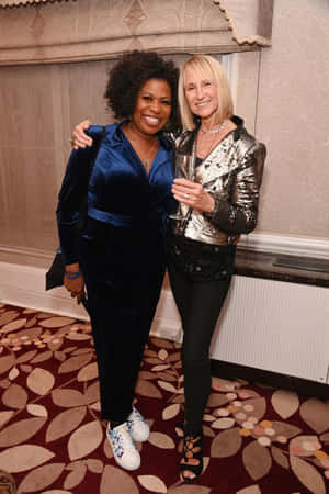 Elegant Event Posing Two Women Wallpaper