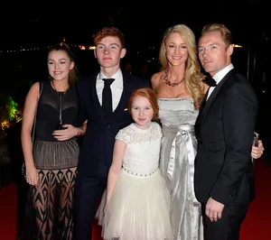 Elegant Family Red Carpet Appearance Wallpaper