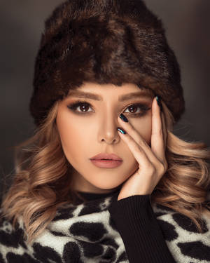 Elegant Fashion Model Donning Exclusive Brown Fur Wallpaper