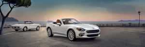 Elegant Fiat 124 Spider On The Open Road Wallpaper