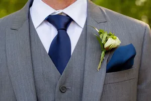 Elegant Groom Navy Blue Tieand Boutonniere Wallpaper
