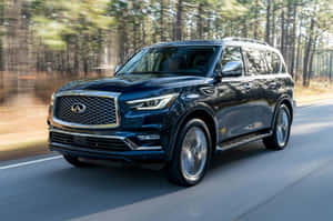 Elegant Infiniti Qx80 Cruising On The Road Wallpaper