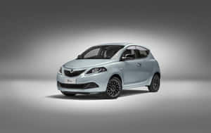 Elegant Lancia Ypsilon In Motion Wallpaper